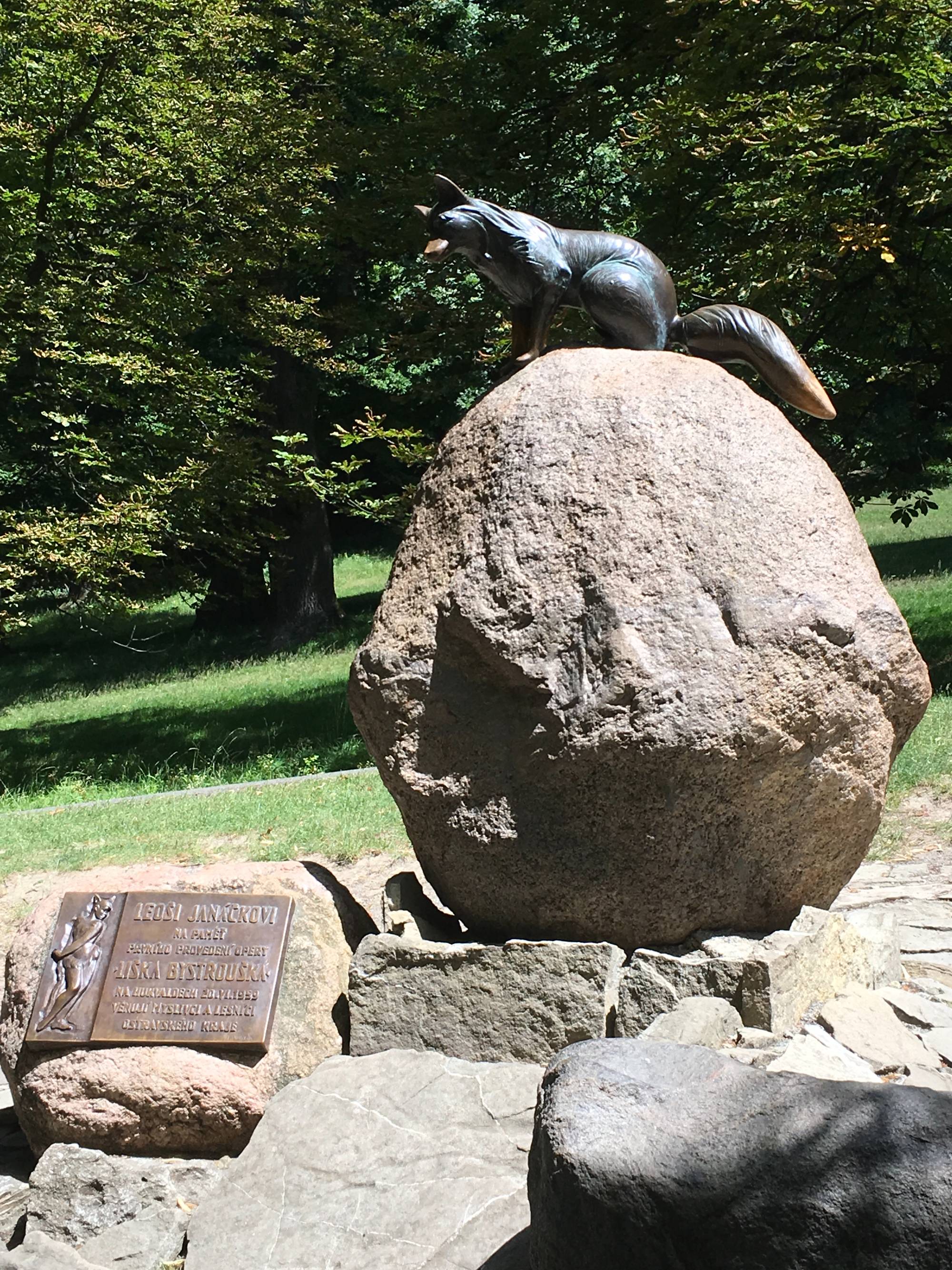 A statue of little vixen on a stone.